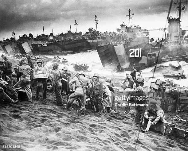 Iwo Jima, Japan-Navy landing craft disgorge tons of supplies onto the shores of Iwo Jima, teeming with activity just a few hours after U.S. Marines...