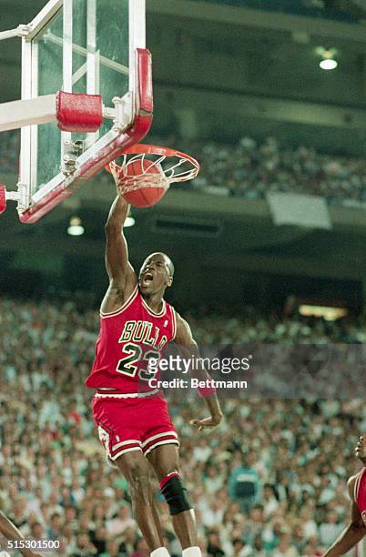 Pontiac, MI-Chicago Bulls superstar Michael Jordan slams two of his 36 points, and screams, to lead the Bulls to a 105-95 win over the Detroit...