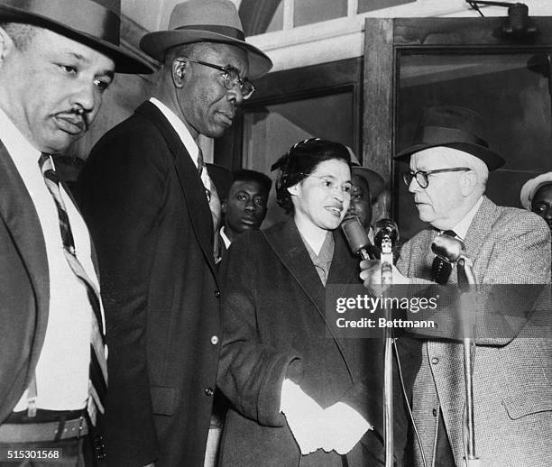 American civil rights activist, Rosa Parks, speaks with an interviewer as she arrives at court with Reverend Edward Nixon and 91 other...