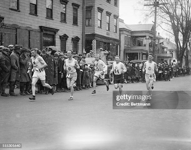 Boston, MA- Photo shows runners coming through Framingham 30 mninutes after the start of the Boston Marathon. Clarence DeMar is no. 1.