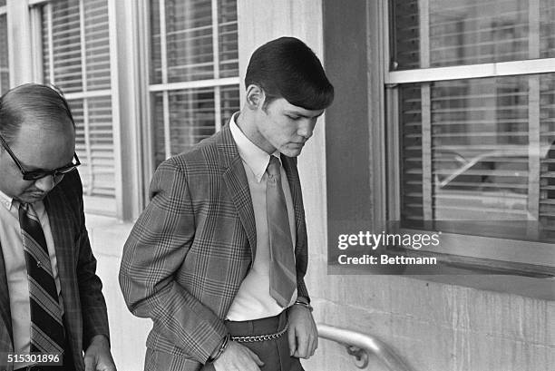 Ann Arbor, MI-John Norman Collins, manacled to a chain around his waist, leaves the Washtenshaw County Courthouse 8/19 after a jury of six men and...