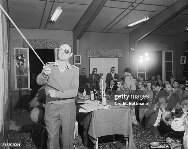 Tel Aviv, Israel-Major General Moshe Dayan,Chief of Staff of Israeli forces,gestures with a pointer during a news conference here.Dayan promised that...