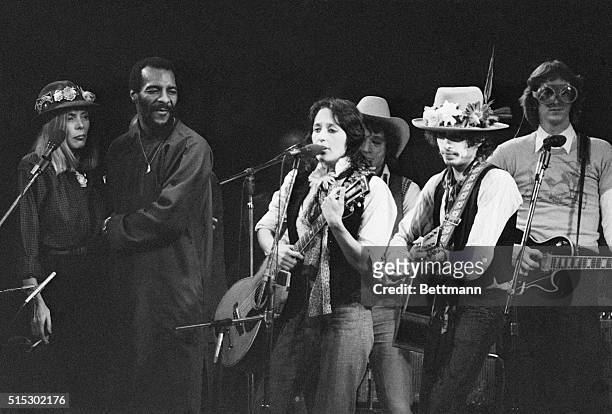 Joan Baez, Bob Dylan, Joni Mitchell, and Richie Havens perform at a fundraising concert for boxer Rubin "Hurricane" Carter who maintains his...