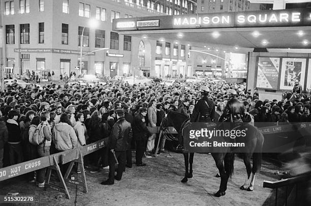 New York, New York- An orderly crowd of ticket holders for the rock group the Rolling Stones performance at Madison Square Garden file through police...