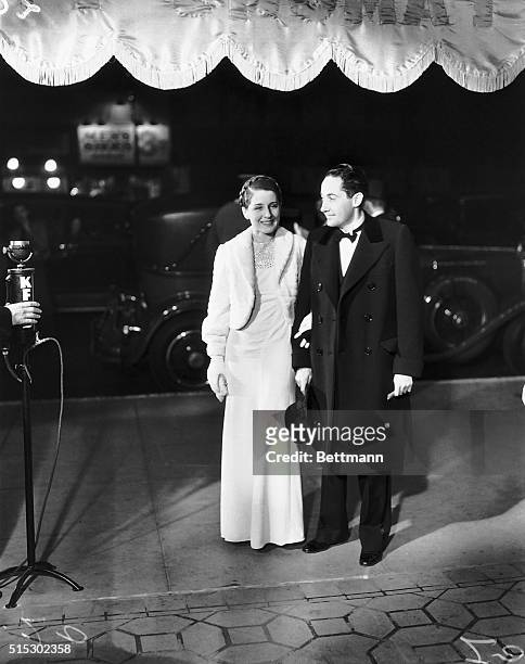 Photo shows actress Norma Shearer and her husband, movie producer and writer Irving Thalberg, as they arrive at what appears to be a black-tie affair.