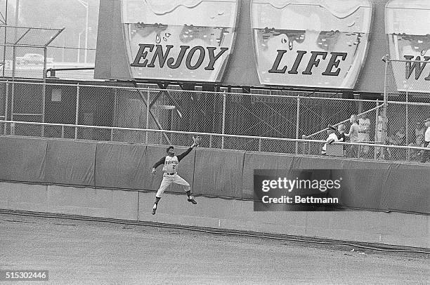 Roberto Clemente of the Pittsburgh Pirates catching a field ball.