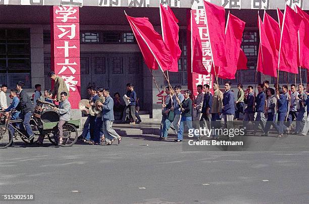 Members of the Red Guards march in demonstrations in Canton, China. Thousands of adolescents and young adults were enlisted into the Red Guards to...