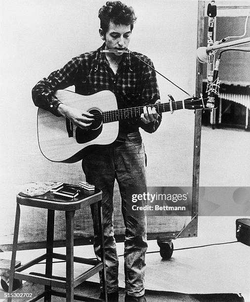American folk singer Bob Dylan in a recording studio, circa 1962.