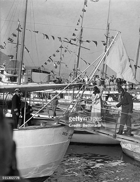 Monaco- Princess Grace and Prince Rainier acknowledge farewells as they board the Royal Yacht, the "Deo Juvante 11", April 19, to begin their...