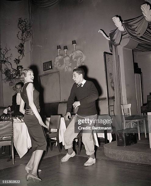 Stage actress Alicia Klug and stage actor Eddie Weston, from the Broadway version of Gentlemen Prefer Blondes, practice the Charleston at a nightclub...