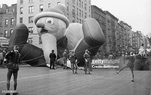 Parade participants hold ropes attached to the Santa Claus parade balloon as it collapses during the annual Macy's Thanksgiving Day Parade in New...