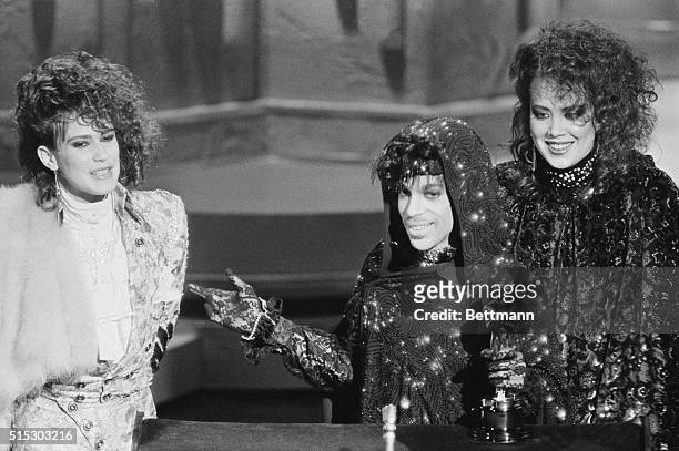 Los Angeles, CA- Prince and members of his group accept their Oscar for Best Original Song Score for "Purple Rain."