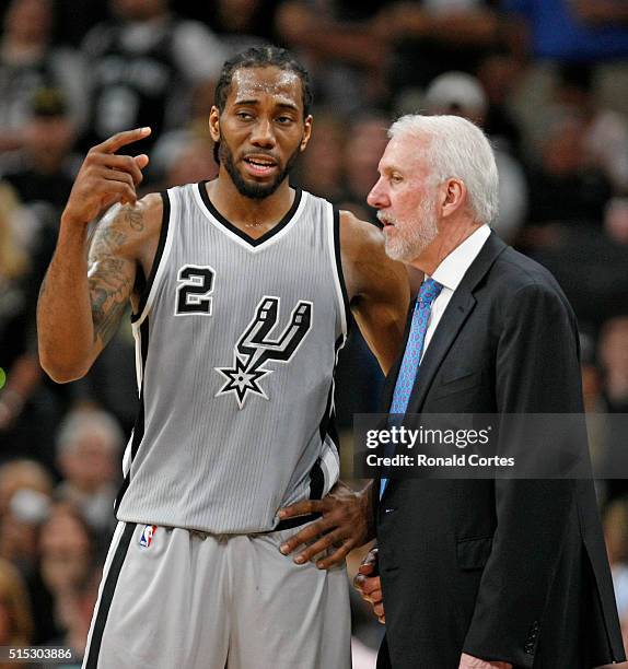 Kawhi Leonard of the San Antonio Spurs talks with head coach Gregg Popovich at AT&T Center on March 12, 2016 in San Antonio, Texas. NOTE TO USER:...