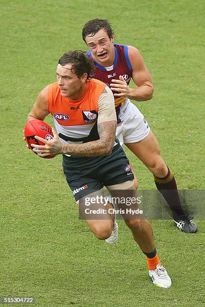 Nathan Wilson of the Giants runs the ball during the NAB Challenge AFL match between the Brisbane Lions and the Greater Western Sydney Giants at...