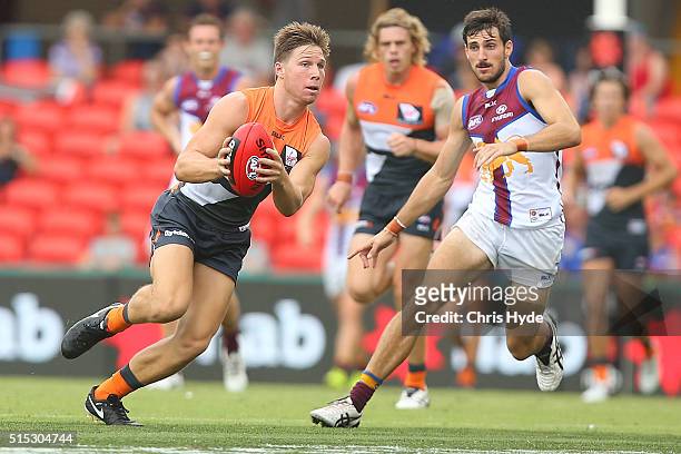 Toby Greene of the Giants runs the ball during the NAB Challenge AFL match between the Brisbane Lions and the Greater Western Sydney Giants at...