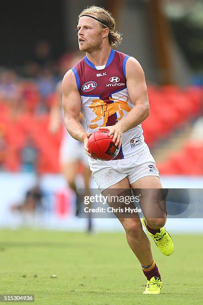 Daniel Rich of the kicks during the NAB Challenge AFL match between the Brisbane Lions and the Greater Western Sydney Giants at Metricon Stadium on...