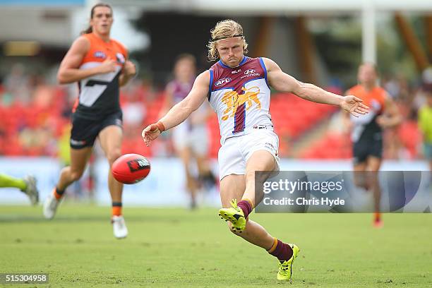 Daniel Rich of the kicks during the NAB Challenge AFL match between the Brisbane Lions and the Greater Western Sydney Giants at Metricon Stadium on...