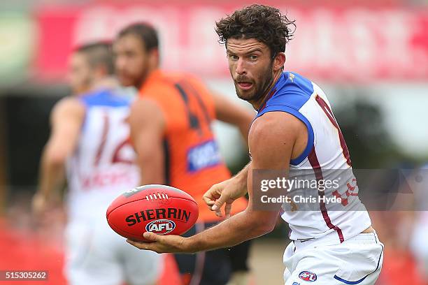 Rohan Bewick of the Lions handballs during the NAB Challenge AFL match between the Brisbane Lions and the Greater Western Sydney Giants at Metricon...