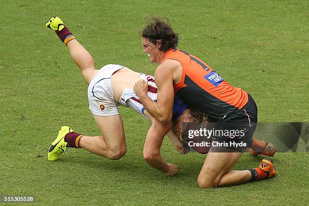 Daniel Rich of the Lions is tackled by Ben Keays of the Giants during the NAB Challenge AFL match between the Brisbane Lions and the Greater Western...