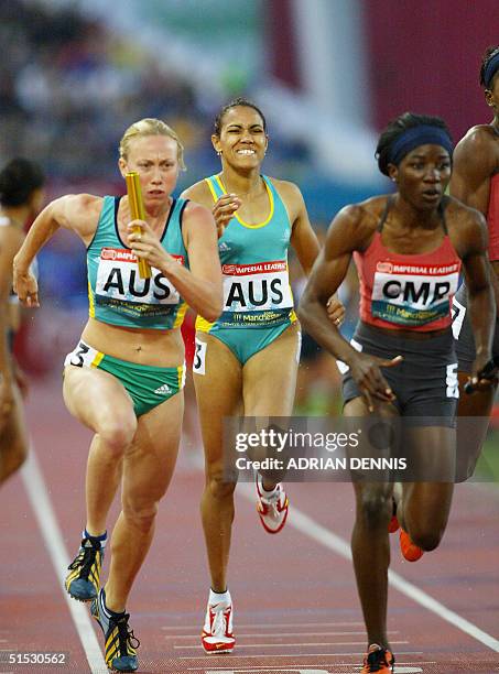 Australia's Cathy Freeman grimaces after handing the baton over to her teammate Tamsyn Lewis during the womens 4x400 metre relay semi final during...