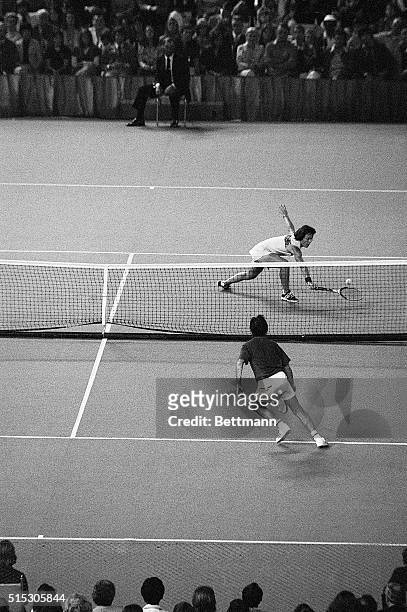 Billie Jean King reaches for a low volley in her tennis match against Bobby Riggs. Riggs boasted earlier in the year that no woman could beat a male...