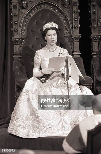 Making history, Queen Elizabeth II becomes the first reigning monarch to open a session of the Canadian Parliament as she reads a speech from the...