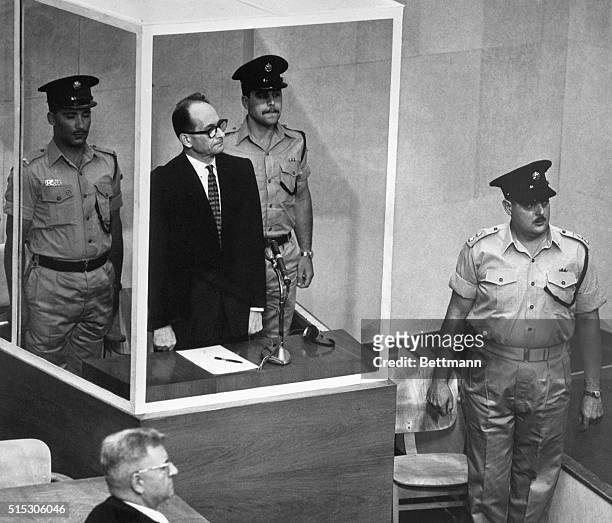 Jerusalem, Israel- Adolf Eichmann, accused Nazi mass murderer, stands in his bullet-proof glass cage to hear Israel's Supreme Court unanimously...