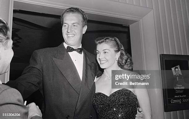 Framed in a doorway, Esther Williams and her radio announcer husband, Ben Gage greet friends at a Hollywood night club. For the evening of fun the...