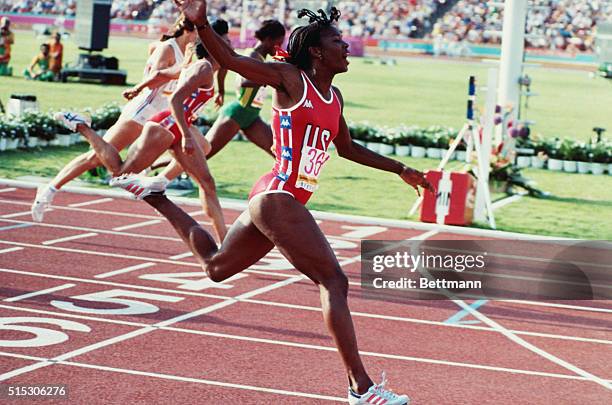 Valerie Brisco-Hooks of the USA moves into the lead to win the gold in the women's 400 meter final Monday. Kathryn Cook of Britain won the bronze,...