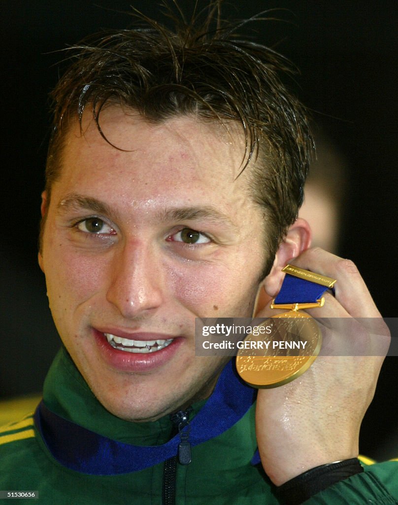 Australian Ian Thorpe poses with his gold medal during the 2002… News