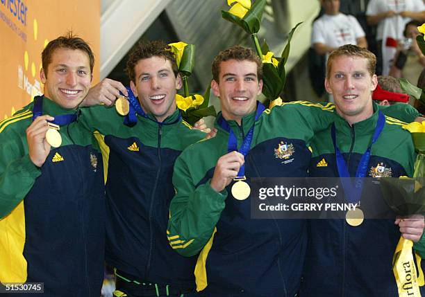 Australian Ian Thorpe, Grant Hackett, Leon Dunne and Jason Cram pose with their gold medals after the 2002 Manchester Commonwealth Games men's 4x200m...