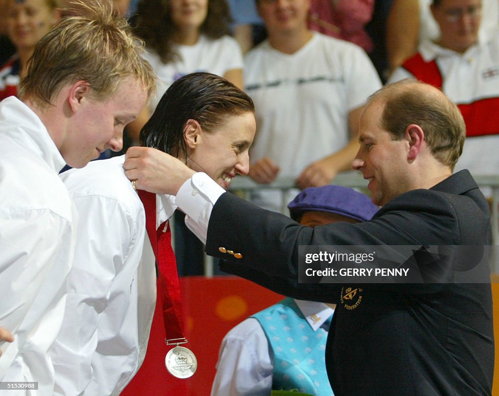 Prince Edward gives the silver medal to England's