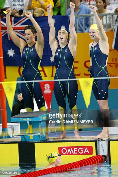 Australian team Dyana Calub, Petria Thomas, Leisel Jones, and Jodie Henry celebrate after winning the 2002 Manchester Commonwealth Games women's...