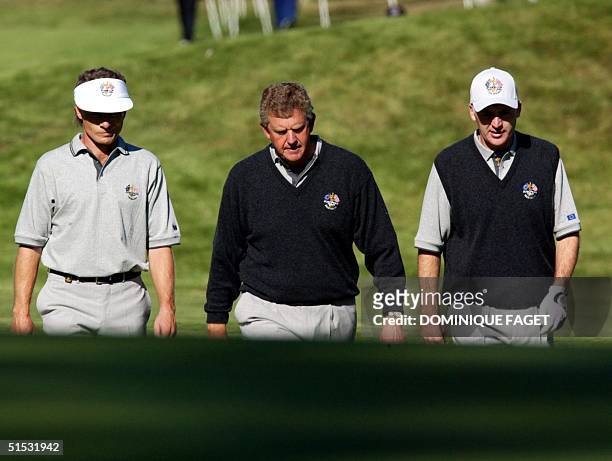 European Ryder Cup golfers Bernhard Langer of Germany, Colin Montgomerie of Scotland and Phillip Price of Wales walk to the 16th hole of the Barbazon...