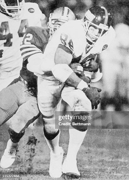 Giants' TE Mark Bavaro drags 49er defender Ronnie Lott#42 going 32 yards on a pass play in 3rd quarter 12/1/86.