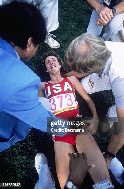 Mary Decker is helped beside the track after being crowded by Zola Budd and injured during the women's 3000 meter final in the Coliseum.
