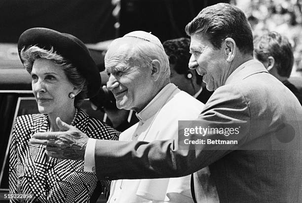 Miami, FL- President and Mrs. Reagan greet Pope John Paul II upon his arrival to begin his third Papal visit to America.