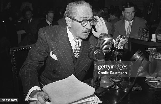 Screen actor Adolphe Menjou, shown testifying before the House Un-American activities committee 10/21/47 declared that Hollywood was a hot bed of...