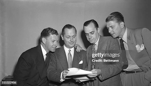 Washington, DC- Huddled in conference before the a session of the House Un-American Activities Committee are : actor, George Murphy; actor, Robert...