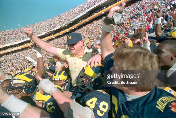 Tempe, Arizona: Michigan football coach Bo Schembechler rides high on his Wolverine's shoulders, January 1st, after winning Fiesta Bowl XV 27-23 over...