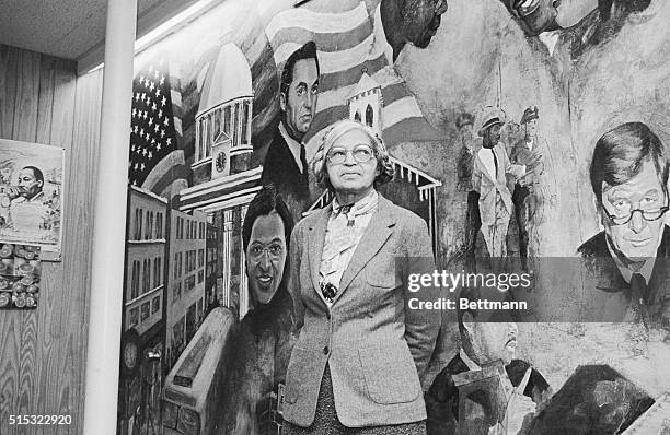 Rosa Parks poses with mural at the Dexter Avenue Martin Luther King Memorial Church which depicts the Civil Rights Movement after holding a news...