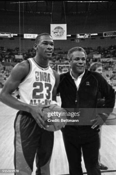 Rookie Michael Jordan, the only rookie starter on the NBA All-Star game, joins with East coach K.C. Jones during a workout for the All-Stars, 2/9....