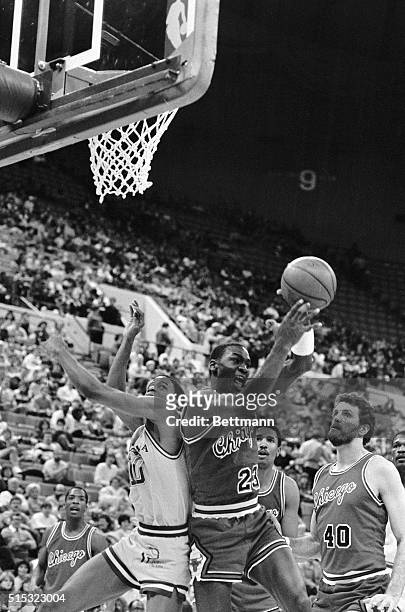 Indiana guard Vern Fleming and Chicago guard Michael Jordan come down back to back after fighting for a rebound during first half of a game 1/19....