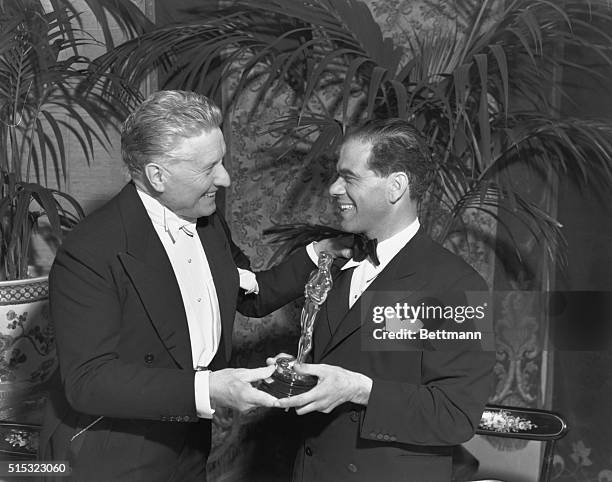 Fred Niblo presents director Frank Capra with his Academy Award for 1938's You Can't Take it with You.