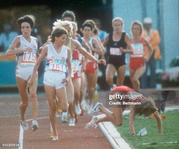 S Mary Decker stumbles as Zola Budd looks over. Outstretched arm directly behind belongs to eventual winner of women's 3000m run.