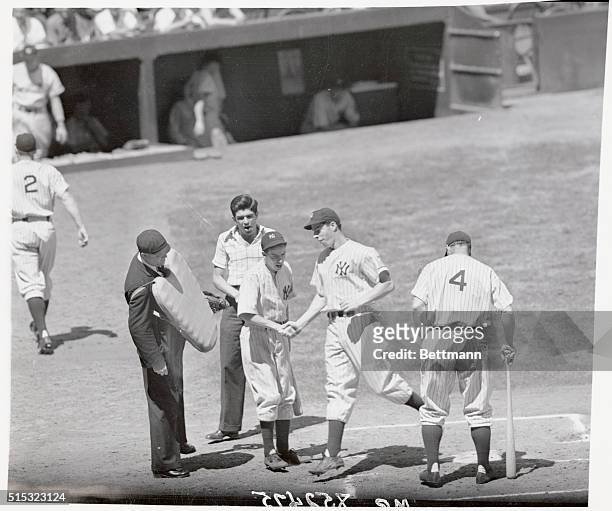 Joe DiMaggio's batting slump is now a thing of the past, and here is DiMag crossing home plate after slamming a homer into the right field stands in...