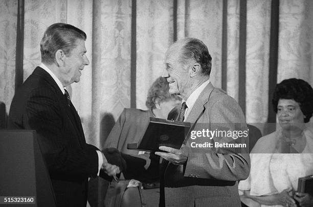 Washington: President Reagan, , presents the presidential Medal of Freedom, the nation's highest civilian award, to Gen. Charles Yeager at a White...