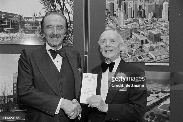 Lord Taylor Woodrow of Hadfield is congratulated by Fred Trump, chairman of the Board of Trump Organization, on his 50 years in America during...