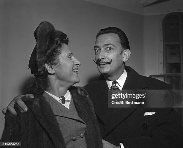 Modernistic artist Salvador Dali amuses his wife, Gala, with a display of his handlebar moustache. The painter-writer and spouse arrived in New York,...