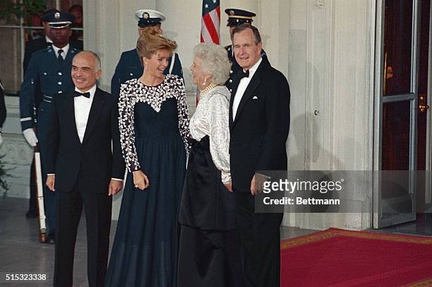 Jordan's King Hussein and wife Queen Noor of Jordan arrive at the White House for State dinner with President Bush and wife Barbara.